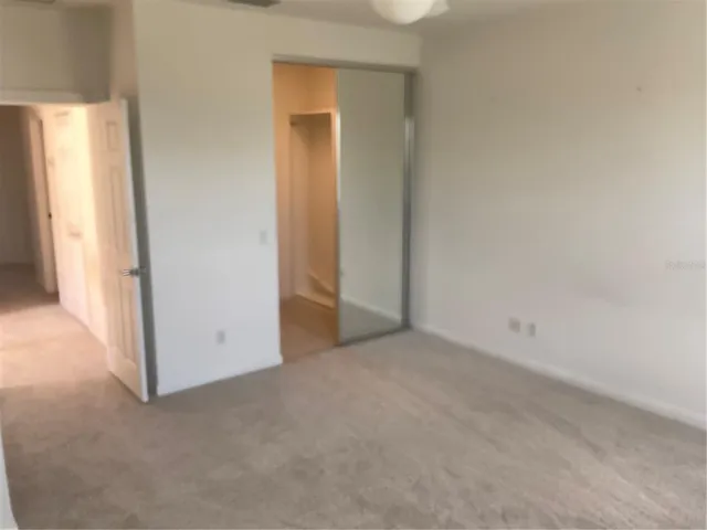 a view of an empty room and a window