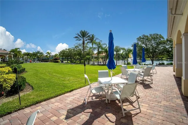 a view of a swimming pool with lounge chairs in patio