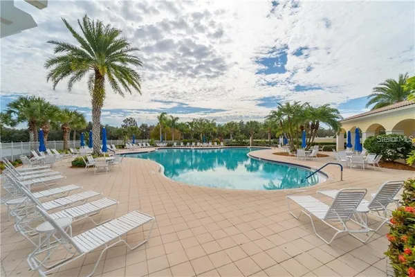 a view of swimming pool with outdoor seating and plants
