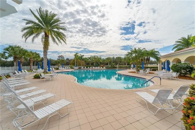 a view of swimming pool with outdoor seating and plants