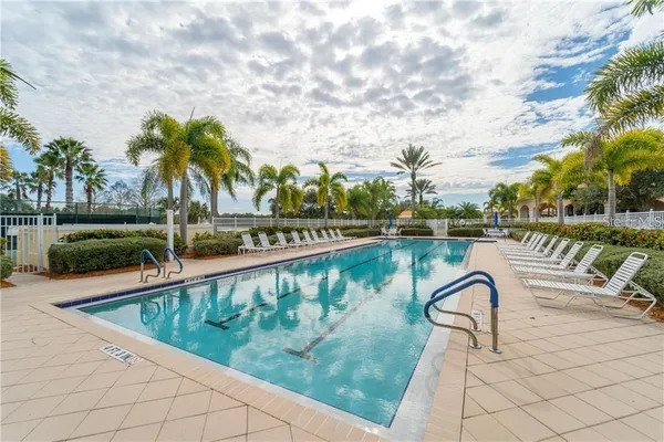 a view of swimming pool with a garden and seating area