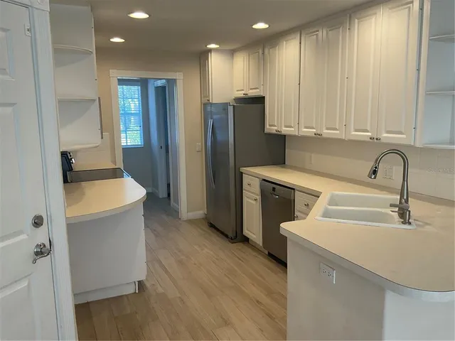 a kitchen with a sink and a refrigerator