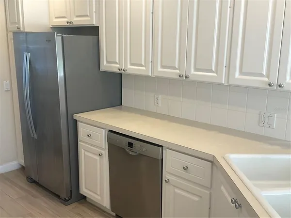 a kitchen with stainless steel appliances a refrigerator and a sink