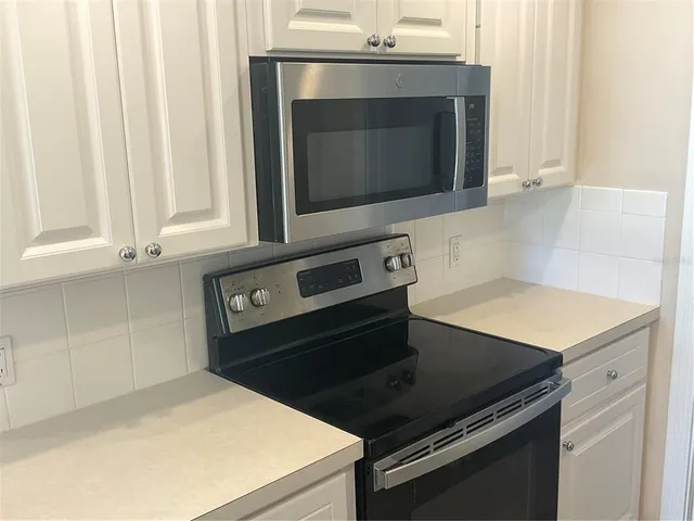 a stove top oven sitting inside of a kitchen