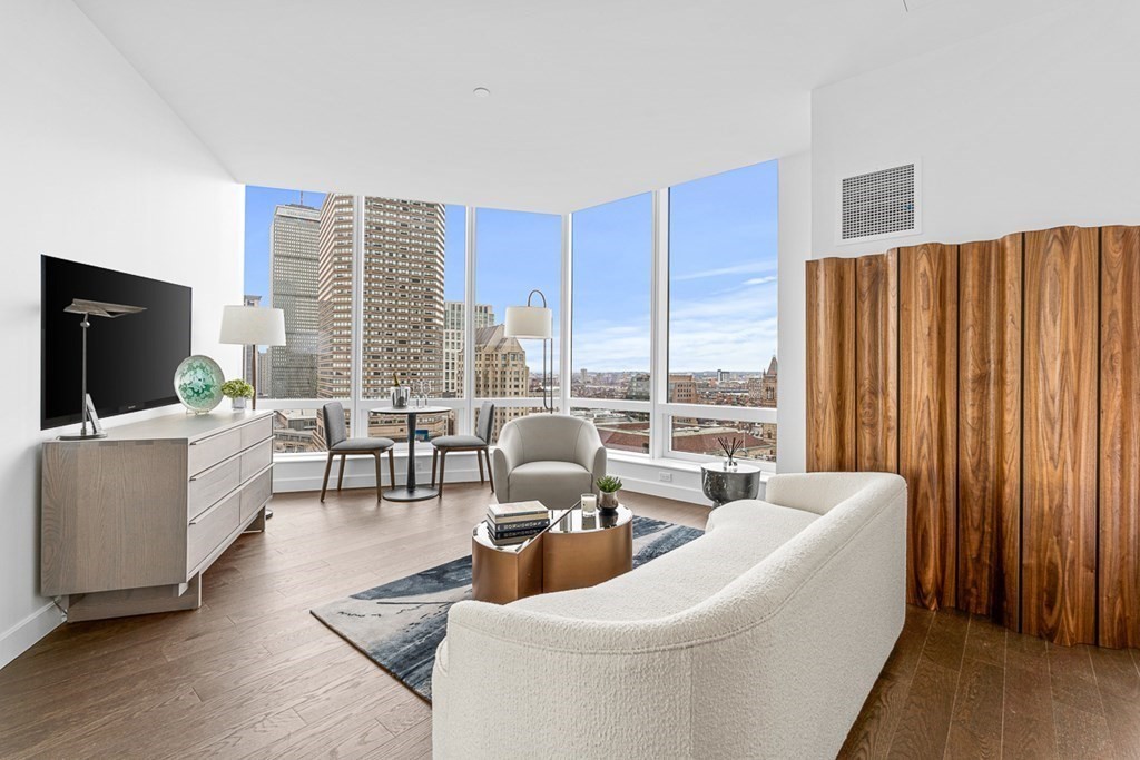 40 Trinity Place, Unit 1614 Boston, MA 02116 - Photo 1 of 26 a living room with furniture a flat screen tv and a large window