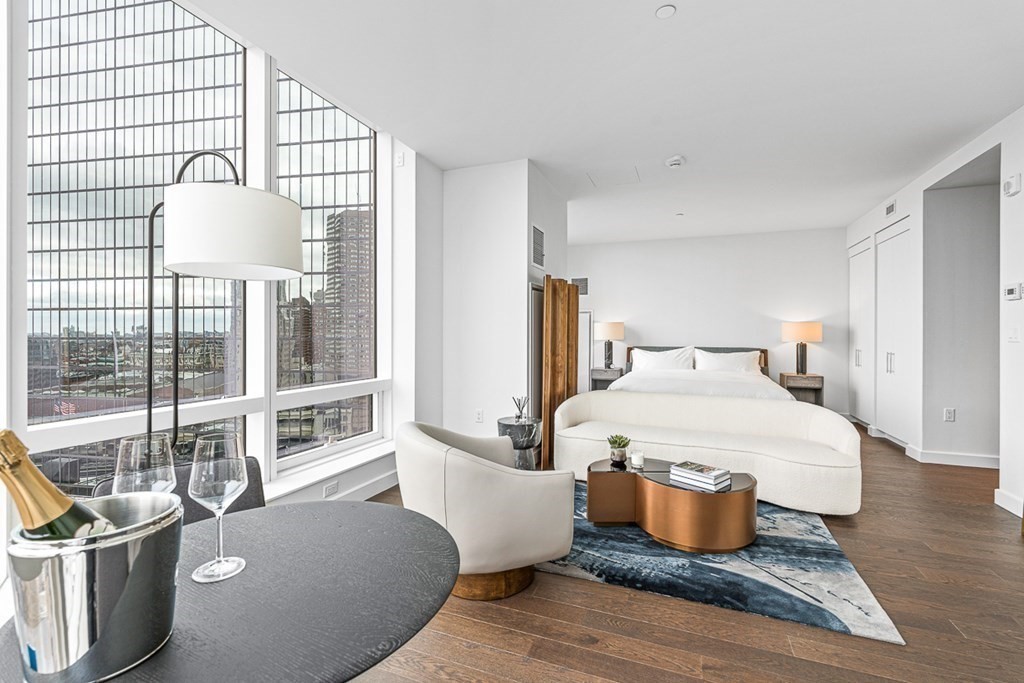 40 Trinity Place, Unit 1614 Boston, MA 02116 - Photo 11 of 26 a bedroom with a bed and wooden floor