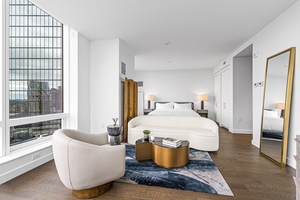 40 Trinity Place, Unit 1614 Boston, MA 02116 - Photo 12 of 26 a spacious bedroom with a bed and wooden floor