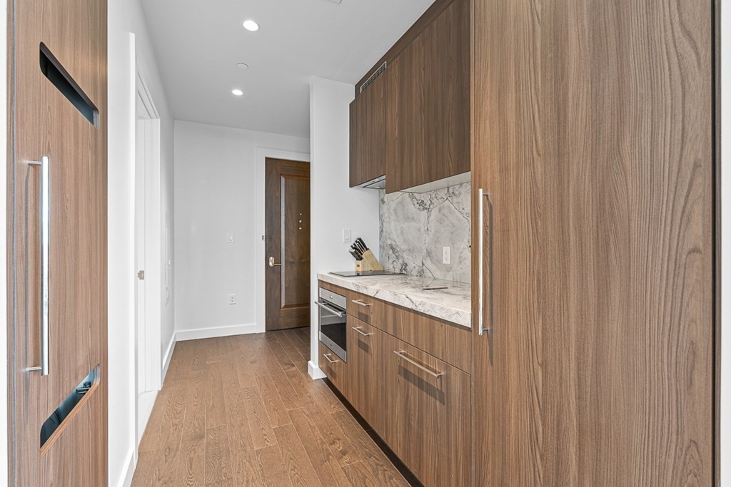 40 Trinity Place, Unit 1614 Boston, MA 02116 - Photo 14 of 26 a kitchen with stainless steel appliances granite countertop a refrigerator and a sink