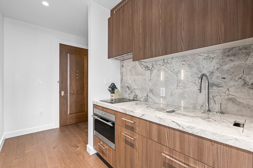 40 Trinity Place, Unit 1614 Boston, MA 02116 - Photo 15 of 26 a kitchen with a sink and a stove