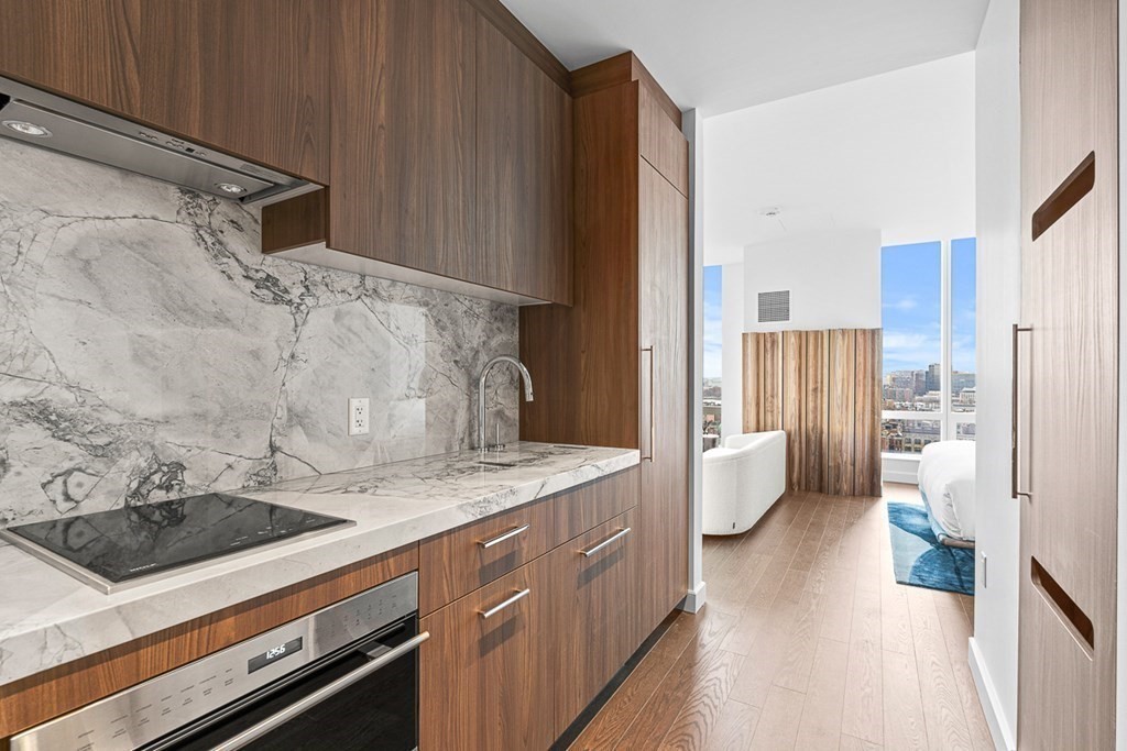 40 Trinity Place, Unit 1614 Boston, MA 02116 - Photo 16 of 26 a spacious bathroom with a granite countertop sink and a mirror