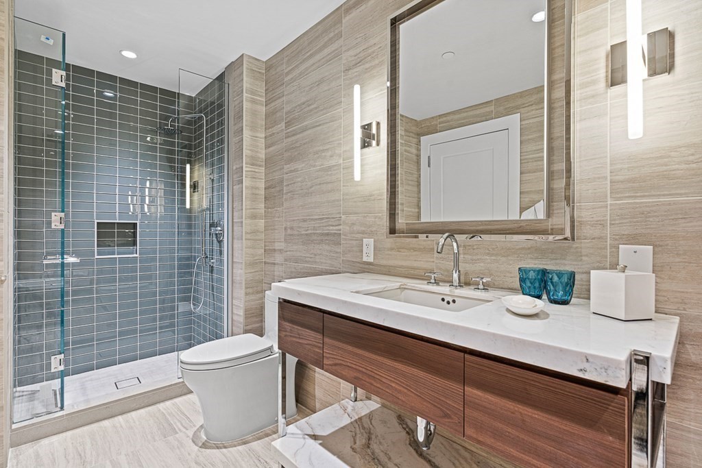40 Trinity Place, Unit 1614 Boston, MA 02116 - Photo 19 of 26 a bathroom with a sink toilet and shower