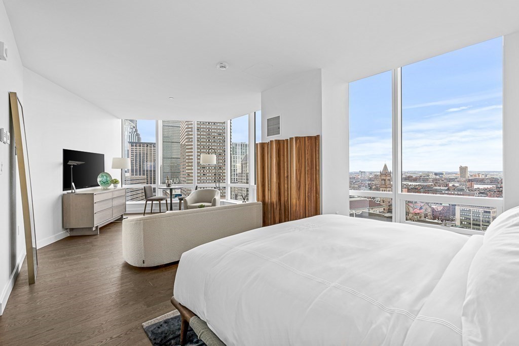 40 Trinity Place, Unit 1614 Boston, MA 02116 - Photo 5 of 26 a bedroom with a large bed and a large window