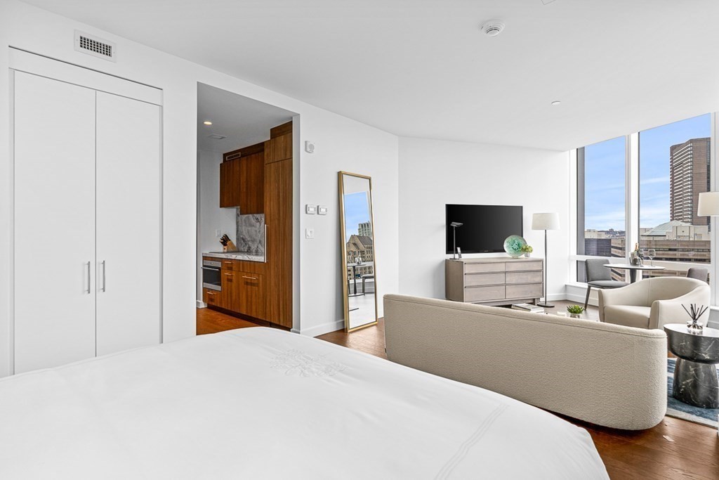 40 Trinity Place, Unit 1614 Boston, MA 02116 - Photo 8 of 26 a bedroom with a bed and a flat screen tv