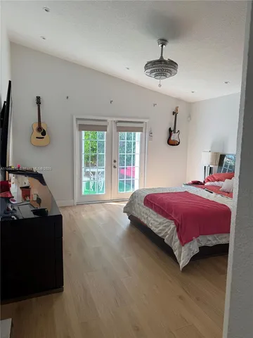 a bedroom with a bed and a chandelier