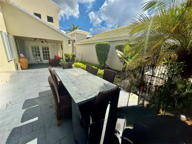 a view of a patio with table and chairs with wooden floor