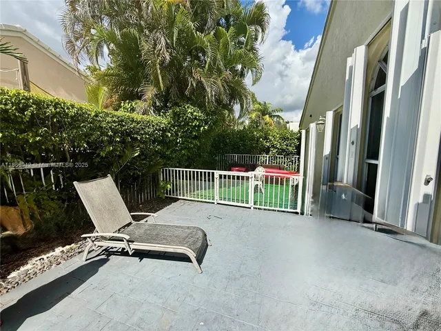 a view of a chair and table in the balcony