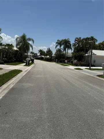 a view of a street with a building in the background