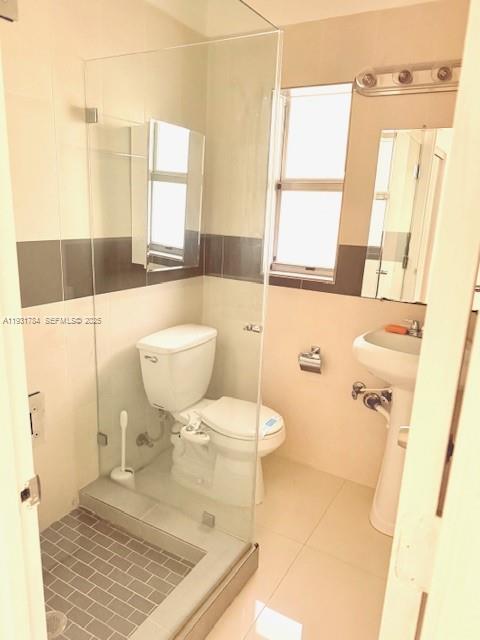 1030 Northeast 80th Street, Unit 1 Miami, FL 33138 - Photo 12 of 22 a bathroom with a granite countertop toilet a sink and a mirror
