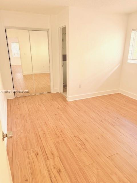 1030 Northeast 80th Street, Unit 1 Miami, FL 33138 - Photo 14 of 22 a view of empty room with wooden floor and fan