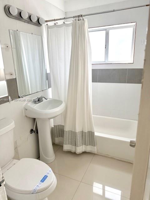 1030 Northeast 80th Street, Unit 1 Miami, FL 33138 - Photo 4 of 22 a bathroom with a sink a toilet a window and a shower