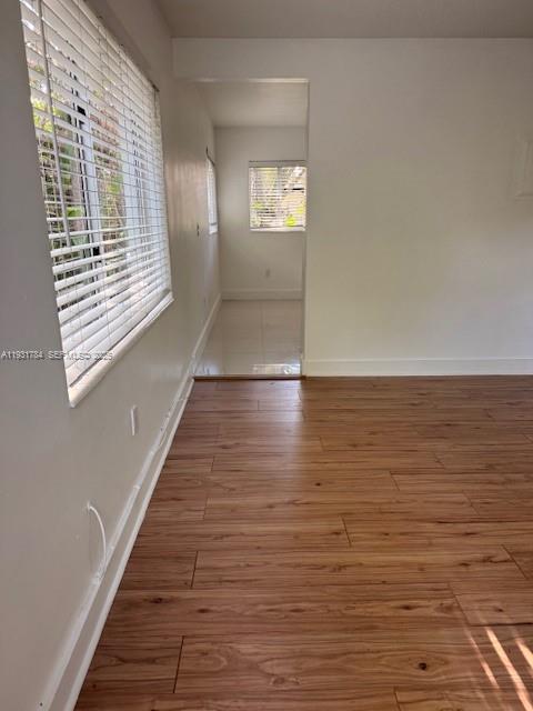 1030 Northeast 80th Street, Unit 1 Miami, FL 33138 - Photo 6 of 22 a view of an empty room with wooden floor and a window