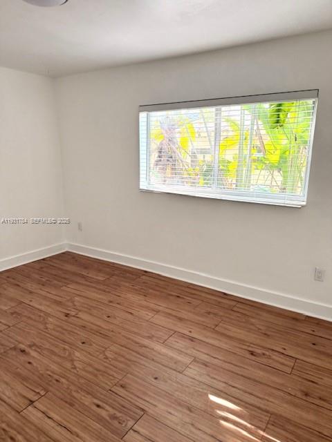 1030 Northeast 80th Street, Unit 1 Miami, FL 33138 - Photo 10 of 22 a view of an empty room with wooden floor and a window