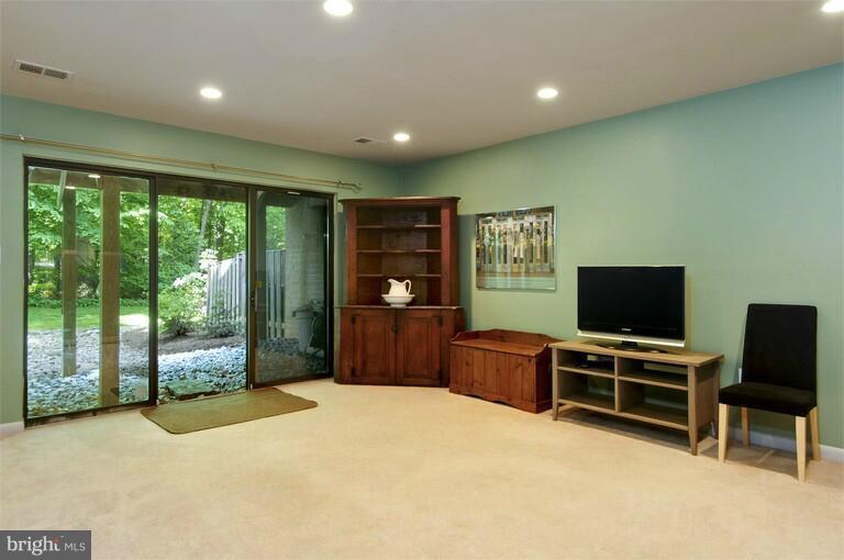 2038 Swans Neck Way Reston, VA 20191 - Photo 1 of 27 a living room with furniture a flat screen tv and floor to ceiling window