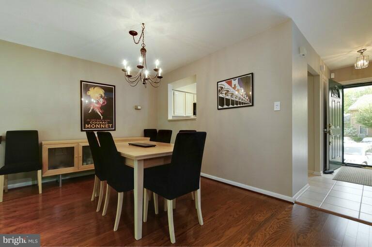 2038 Swans Neck Way Reston, VA 20191 - Photo 17 of 27 a view of a dining room with furniture wooden floor and a chandelier
