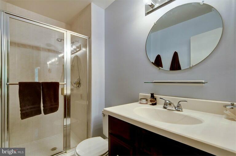 2038 Swans Neck Way Reston, VA 20191 - Photo 22 of 27 a bathroom with a sink and a mirror