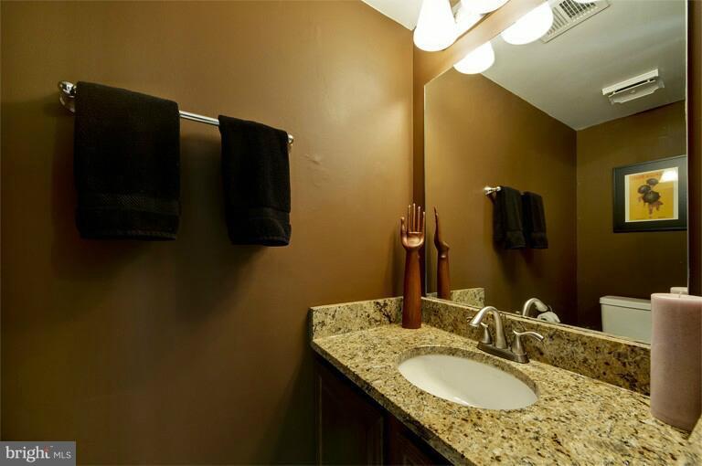 2038 Swans Neck Way Reston, VA 20191 - Photo 9 of 27 a bathroom with a granite countertop sink and a mirror