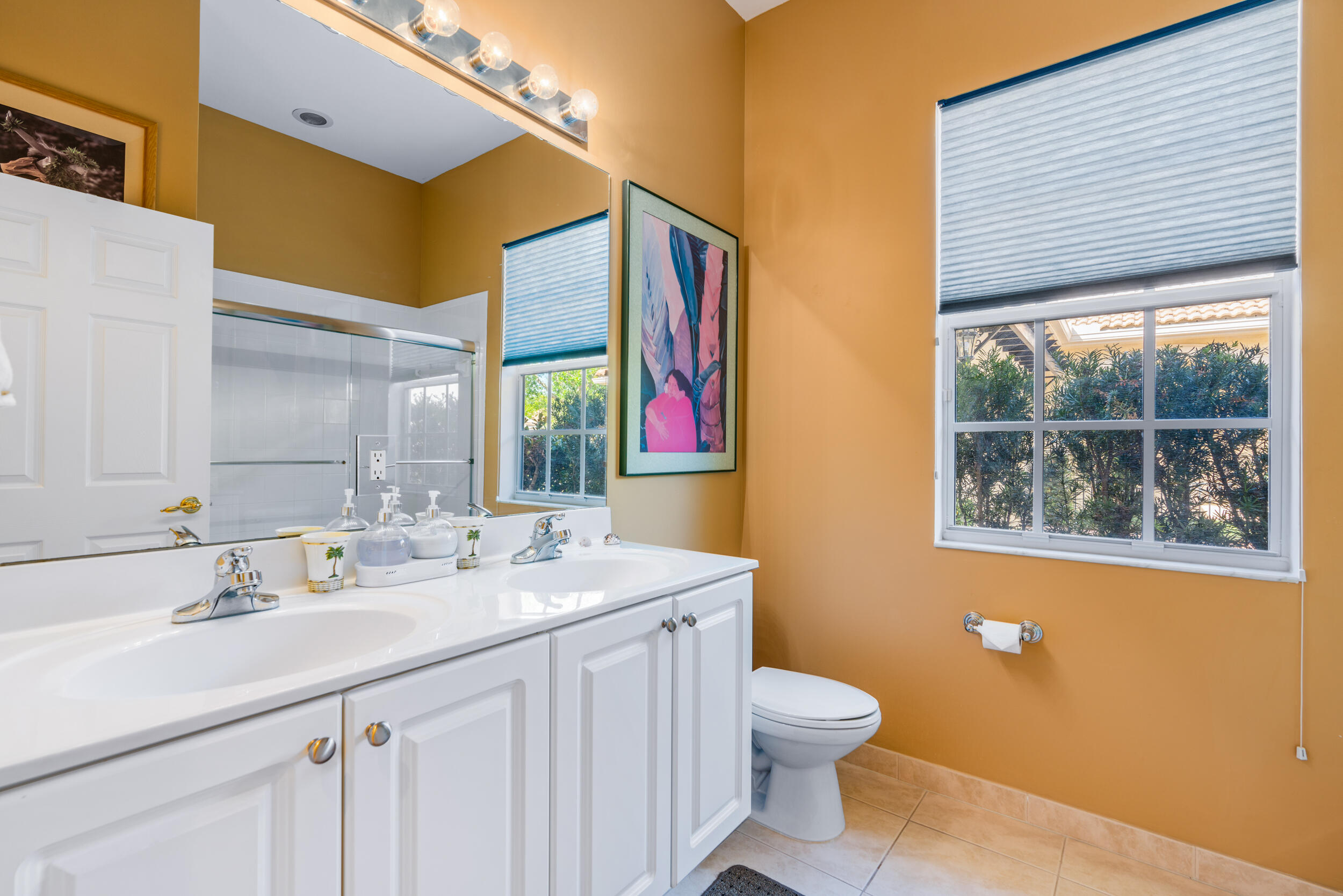 108 Palmfield Way Jupiter, FL 33458 - Photo 18 of 30 a bathroom with a double vanity sink a toilet and a mirror