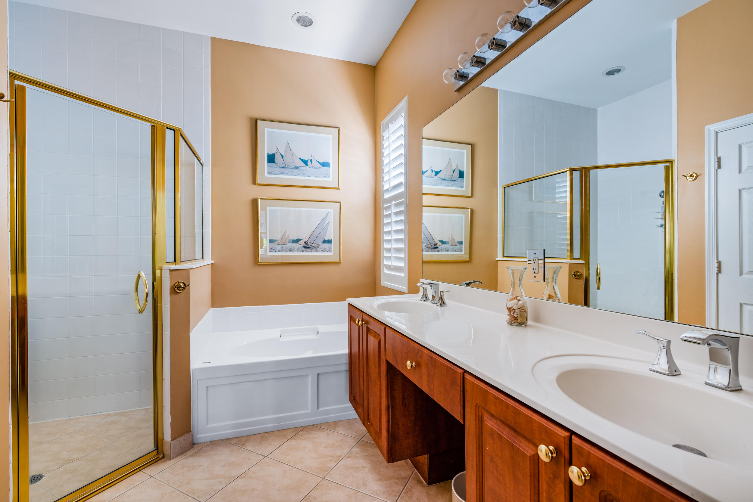 108 Palmfield Way Jupiter, FL 33458 - Photo 22 of 30 a bathroom with a tub double sink window and mirror