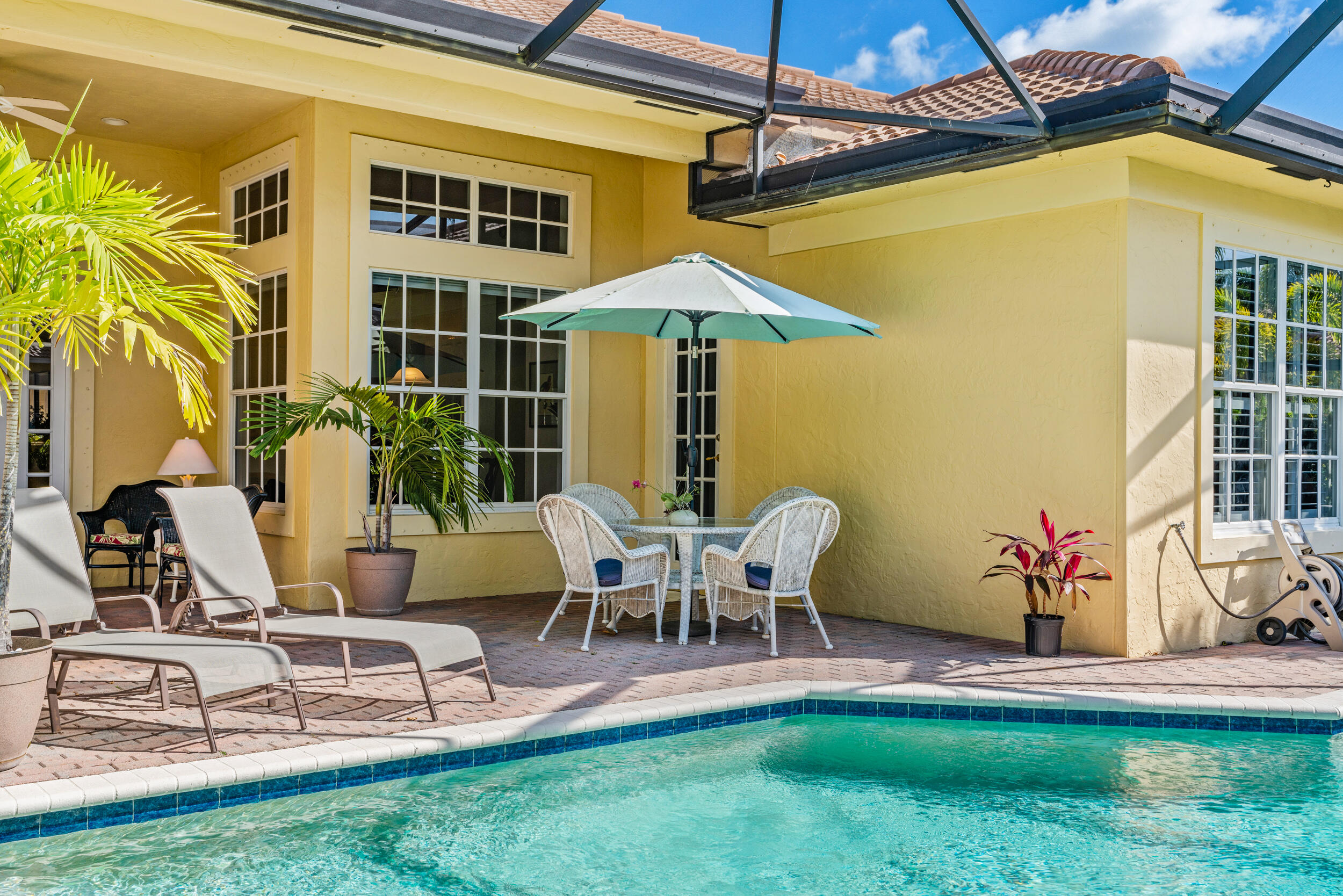 108 Palmfield Way Jupiter, FL 33458 - Photo 5 of 30 a view of a backyard with table and chairs potted plants