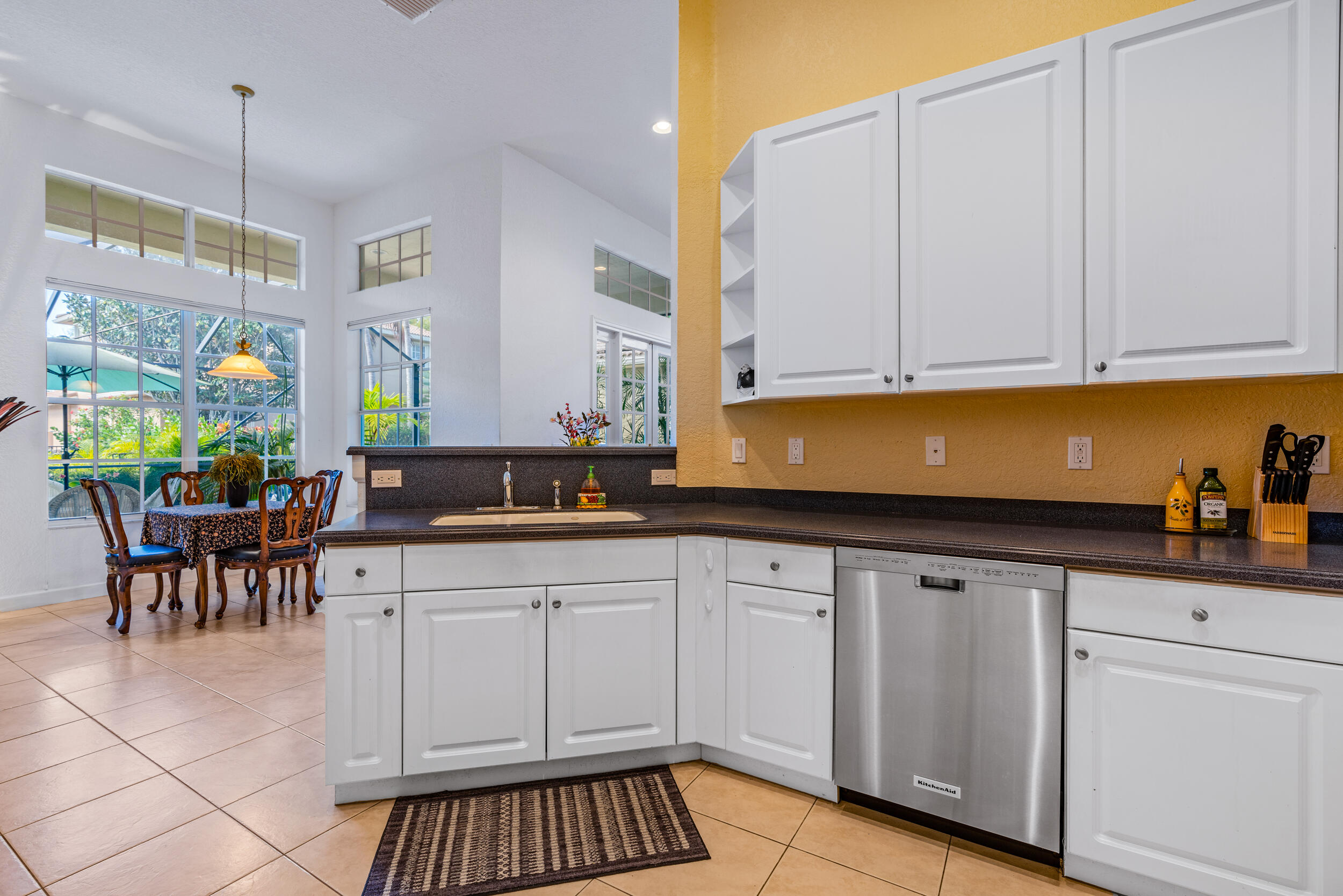 108 Palmfield Way Jupiter, FL 33458 - Photo 10 of 30 a kitchen with white cabinets and sink