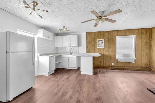a kitchen with stainless steel appliances a refrigerator a sink dishwasher and a stove