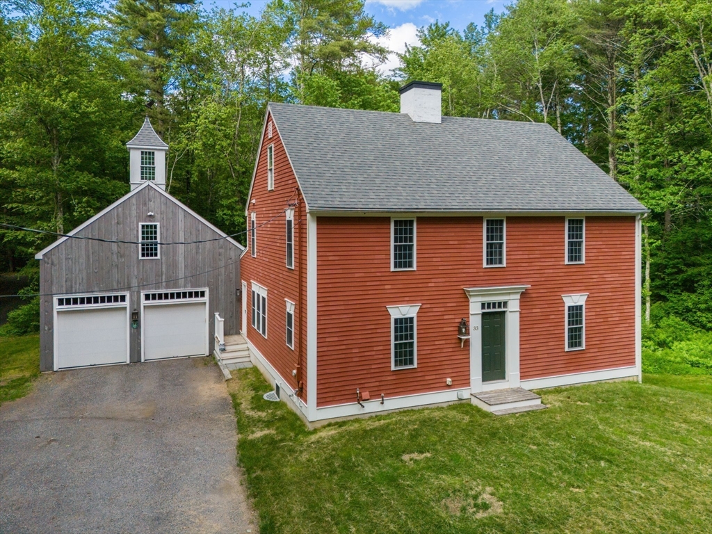 33 Champeaux Road Brimfield, MA 01010 - Photo 32 of 32 a front view of a house with a yard and garage