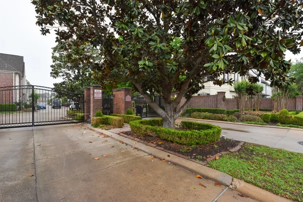 a view of a house with a tree in the background