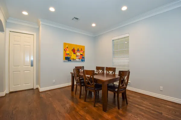a view of a dining room with furniture and wooden floor