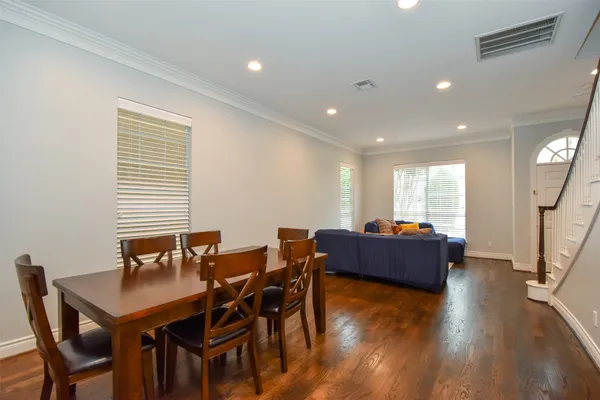 a view of a dining room with furniture and wooden floor