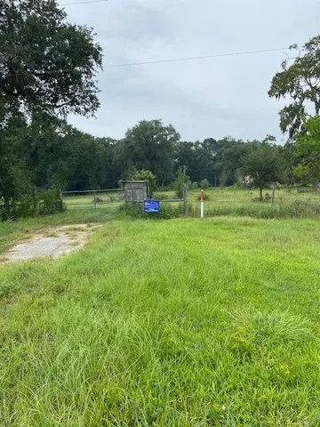a view of outdoor space with green field and trees