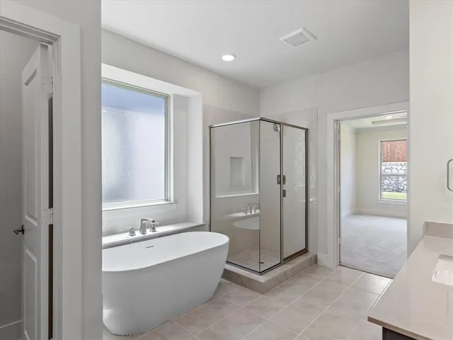 a bathroom with a bathtub and shower