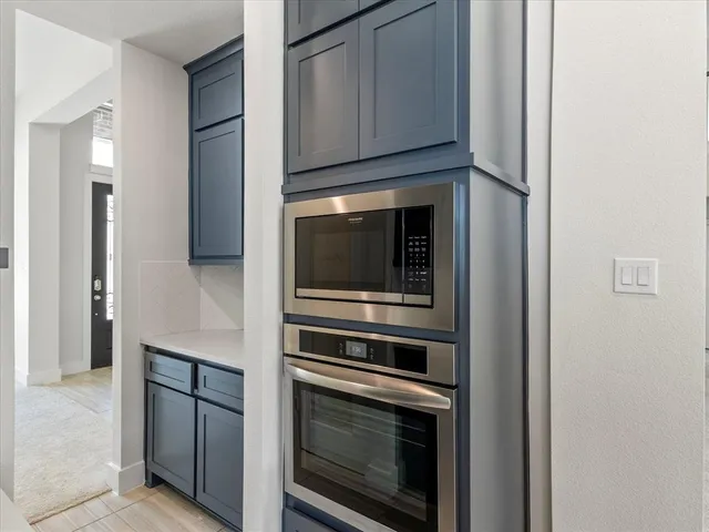 a kitchen with cabinets and stainless steel appliances