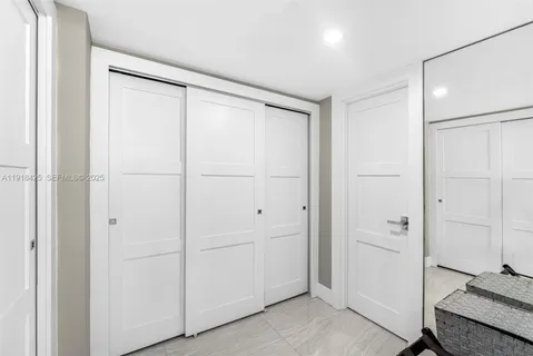 a bathroom with a shower and a glass door
