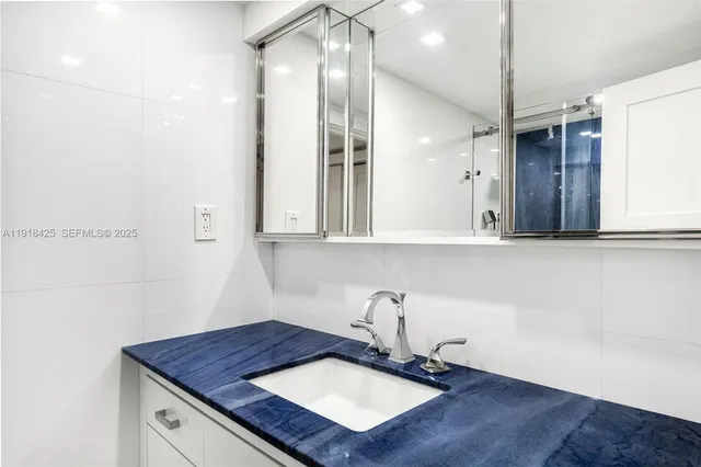 a bathroom with a sink a vanity and a mirror