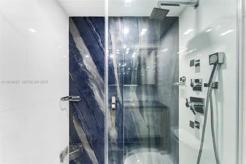 a bathroom with a glass shower door