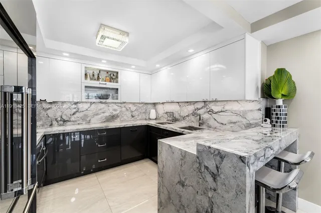 a kitchen with a sink a stove and chairs