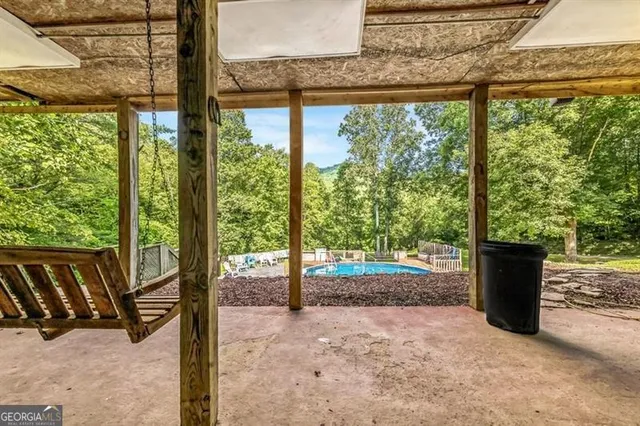 a kitchen with stainless steel appliances granite countertop a refrigerator a stove and a sink with wooden floor