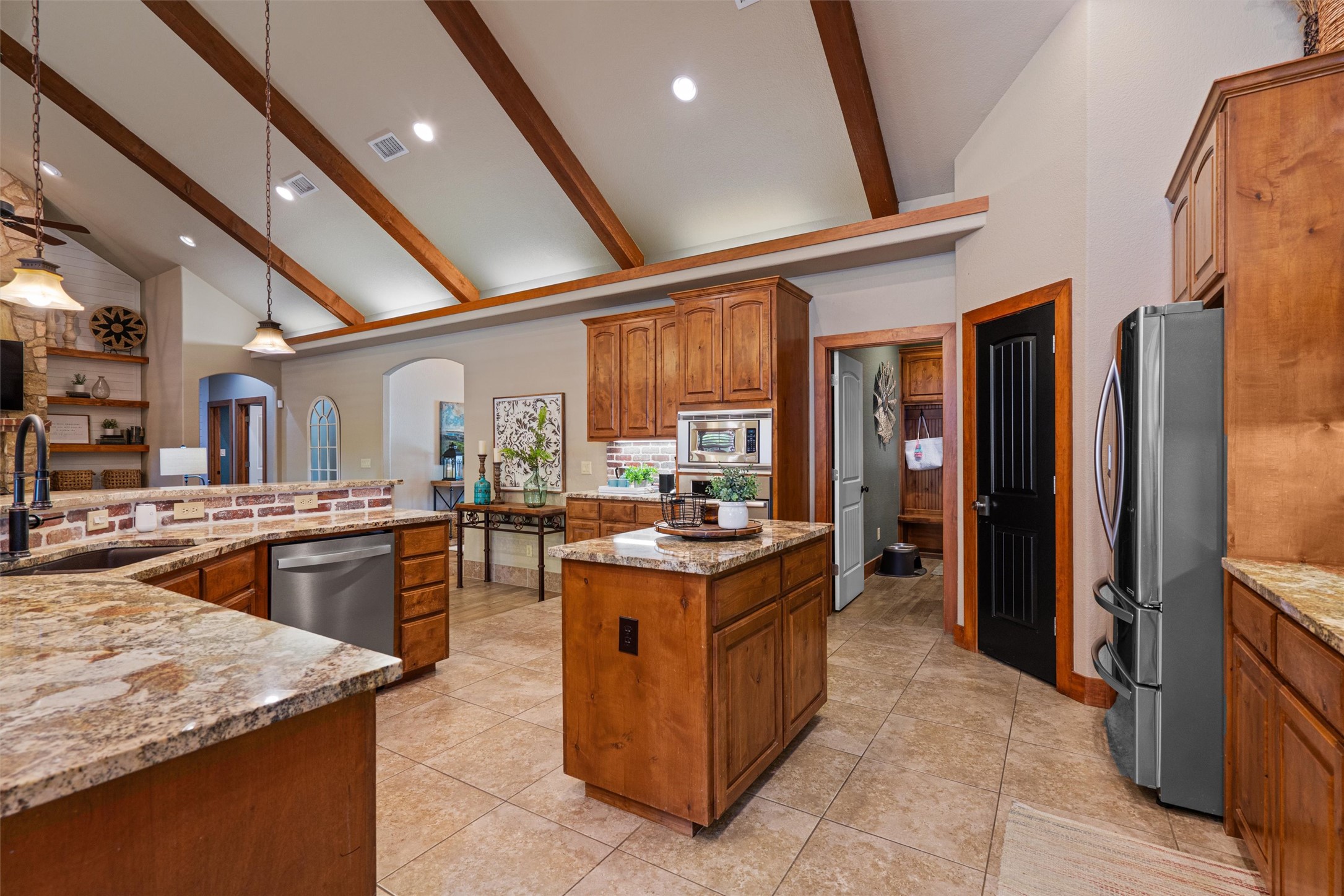 200 Little River Road Liberty Hill, TX 78642 - Photo 12 of 40 a kitchen with granite countertop a stove oven and sink