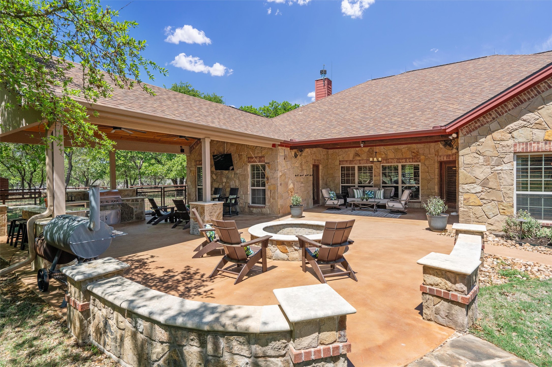 200 Little River Road Liberty Hill, TX 78642 - Photo 27 of 40 a view of a patio with couches and table and chairs under an umbrella