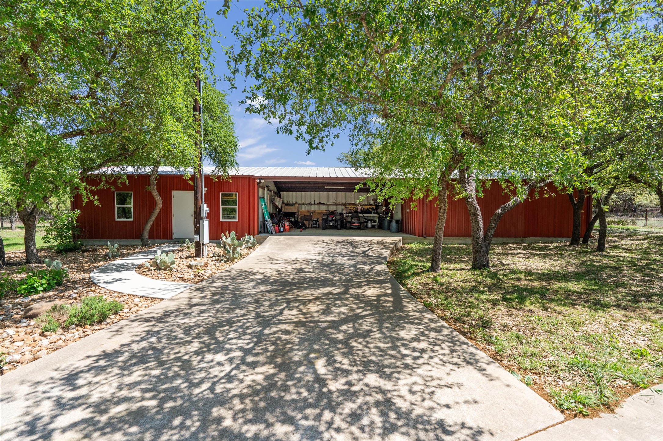 200 Little River Road Liberty Hill, TX 78642 - Photo 38 of 40 a view of a backyard with large trees and wooden fence